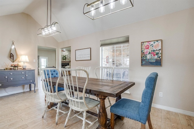 112 Tigers Eye Ct, Weatherford, TX 76087 - dining space with vaulted ceiling, light wood finished floors, a chandelier, and baseboards