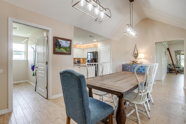 112 Tigers Eye Ct, Weatherford, TX 76087 - dining space with lofted ceiling, baseboards, and light wood-type flooring
