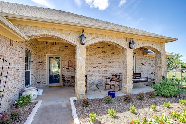 112 Tigers Eye Ct, Weatherford, TX 76087 - doorway to property featuring brick siding and roof with shingles