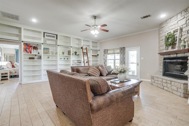 112 Tigers Eye Ct, Weatherford, TX 76087 - living room with crown molding, wood finished floors, a ceiling fan, a stone fireplace, and baseboards