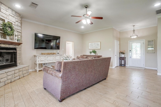 112 Tigers Eye Ct, Weatherford, TX 76087 - living area featuring ceiling fan, light wood finished floors, a fireplace, baseboards, and crown molding