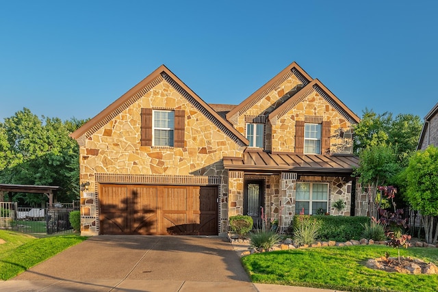 3548 Tuscan Hills Cir, Denton, TX 76210 - view of front of property featuring stone siding, a standing seam roof, driveway, a garage, and metal roof