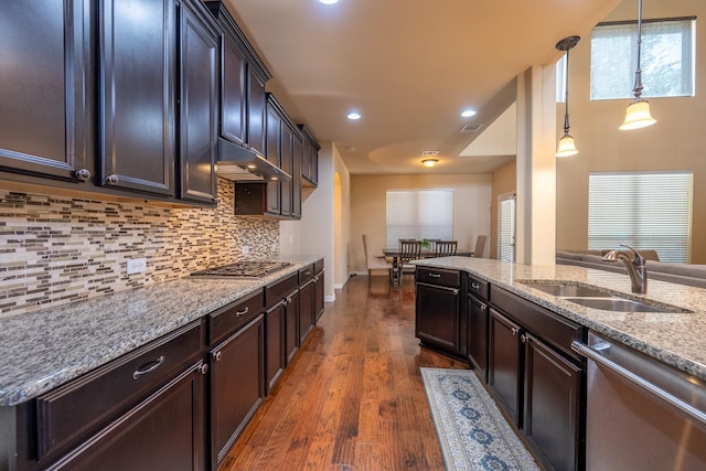 3548 Tuscan Hills Cir, Denton, TX 76210 - kitchen featuring a sink, appliances with stainless steel finishes, under cabinet range hood, light stone counters, and tasteful backsplash
