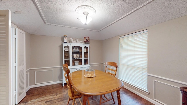 1931 Crestside Cir, Carrollton, TX 75007 - dining room featuring wood finished floors, a textured ceiling, and a wainscoted wall