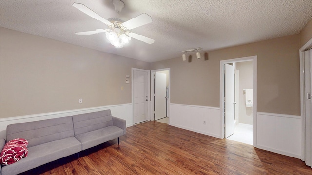 1931 Crestside Cir, Carrollton, TX 75007 - sitting room with a wainscoted wall, wood finished floors, a textured ceiling, and a ceiling fan