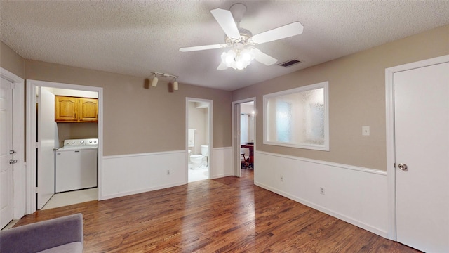 1931 Crestside Cir, Carrollton, TX 75007 - unfurnished living room with washer / clothes dryer, a textured ceiling, wood finished floors, and a ceiling fan