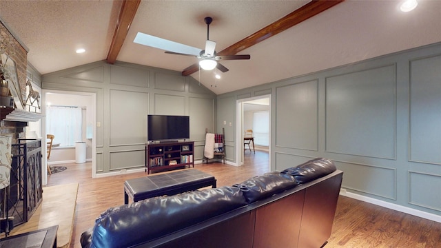 1931 Crestside Cir, Carrollton, TX 75007 - living area featuring a decorative wall, a ceiling fan, wood finished floors, and a fireplace