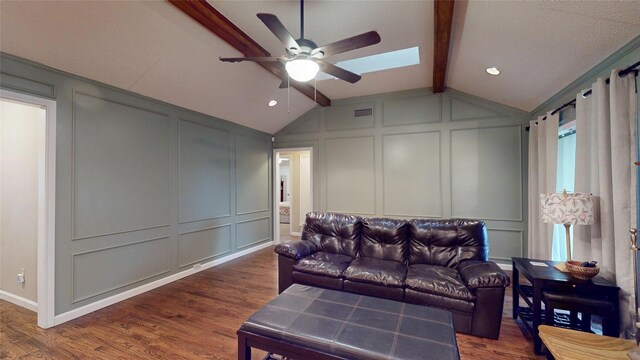1931 Crestside Cir, Carrollton, TX 75007 - living room featuring a decorative wall, a ceiling fan, dark wood-style floors, a skylight, and baseboards