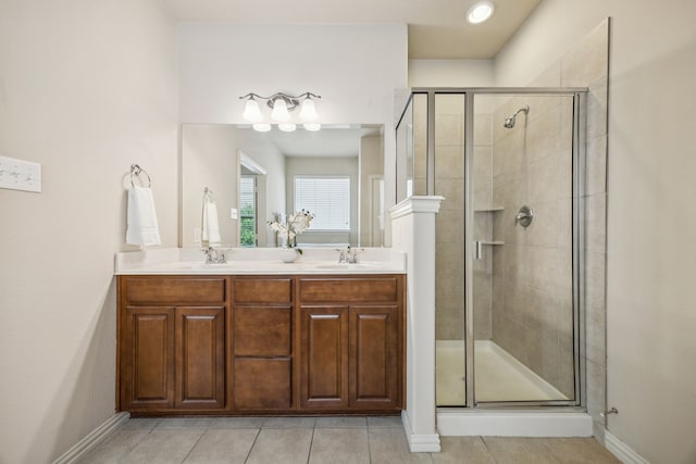 8100 Delaware Dr, Mckinney, TX 75070 - bathroom featuring a shower stall, tile patterned floors, double vanity, and baseboards