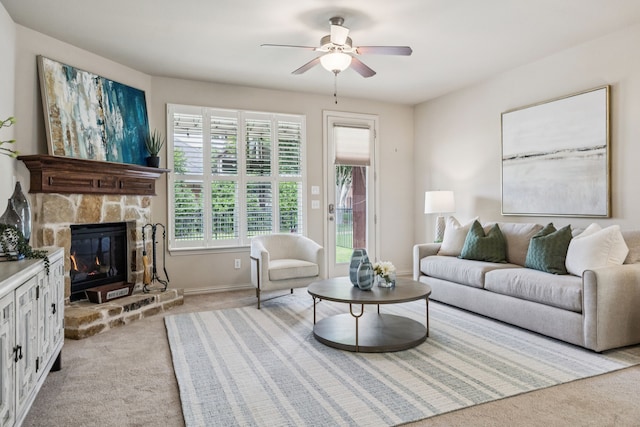 8100 Delaware Dr, Mckinney, TX 75070 - living area with light colored carpet, a ceiling fan, baseboards, and a stone fireplace