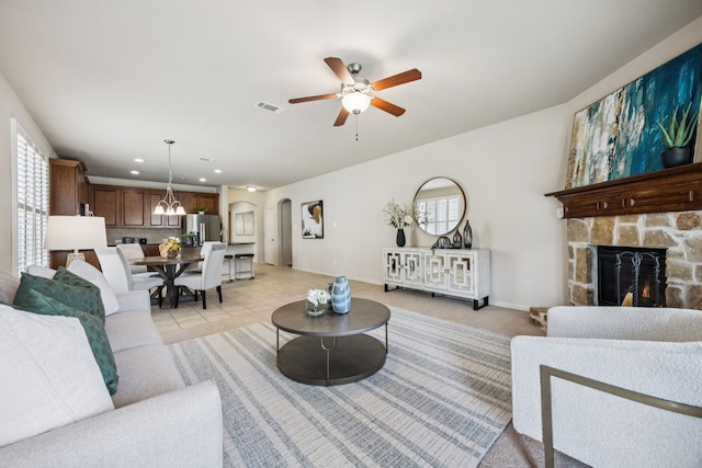 8100 Delaware Dr, Mckinney, TX 75070 - living area with a fireplace, a ceiling fan, arched walkways, plenty of natural light, and recessed lighting