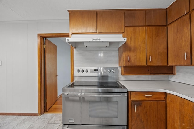 3212 Medina Ave, Fort Worth, TX 76133 - kitchen with double oven range, under cabinet range hood, light countertops, and brown cabinets