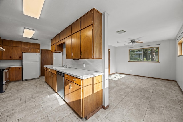 3212 Medina Ave, Fort Worth, TX 76133 - kitchen featuring stainless steel appliances, a sink, light countertops, ceiling fan, and tasteful backsplash