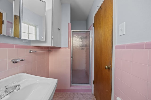 3212 Medina Ave, Fort Worth, TX 76133 - full bathroom with tile walls, a stall shower, tile patterned floors, a sink, and wainscoting