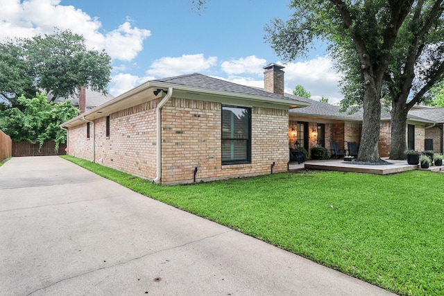1510 Waltham Ct, Arlington, TX 76012 - rear view of house featuring a chimney, brick siding, concrete driveway, and roof with shingles
