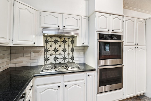 1510 Waltham Ct, Arlington, TX 76012 - kitchen featuring appliances with stainless steel finishes, under cabinet range hood, dark countertops, white cabinets, and tasteful backsplash