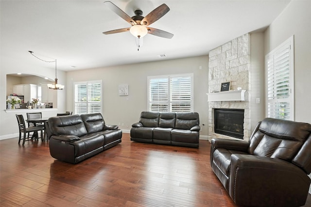 7514 Harbor Dr, Rowlett, TX 75088 - living area with ceiling fan, a chandelier, a stone fireplace, and dark wood-style flooring