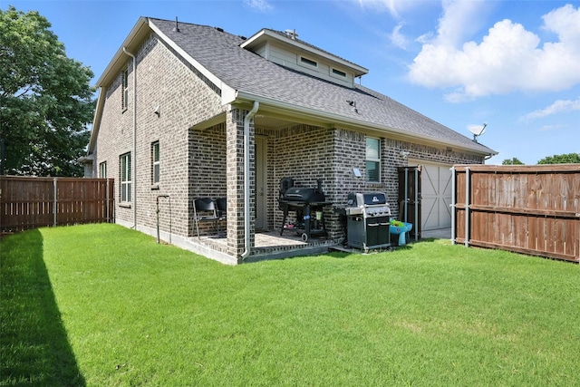 7514 Harbor Dr, Rowlett, TX 75088 - back of house featuring brick siding, a fenced backyard, roof with shingles, and a patio area