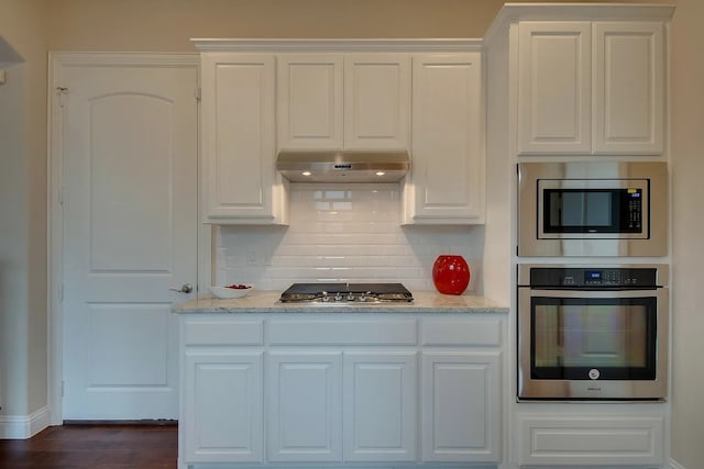 7514 Harbor Dr, Rowlett, TX 75088 - kitchen featuring appliances with stainless steel finishes, under cabinet range hood, tasteful backsplash, and white cabinets