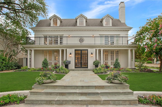 3649 Haynie Ave, University Park, TX 75205 - view of front facade featuring french doors, a chimney, a front yard, and a balcony
