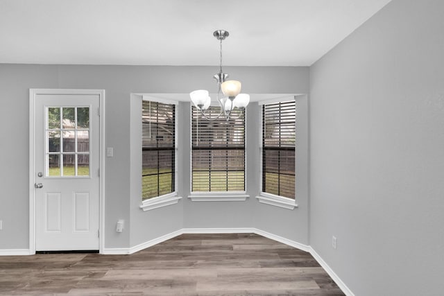 36 Atlantic Ave, Midlothian, TX 76065 - unfurnished dining area featuring a chandelier, wood finished floors, and baseboards