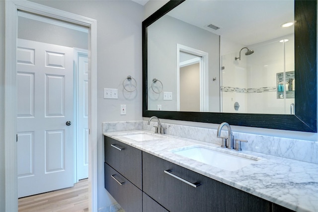 3710 Binkley Ave, University Park, TX 75205 - bathroom featuring double vanity, wood finished floors, and a shower