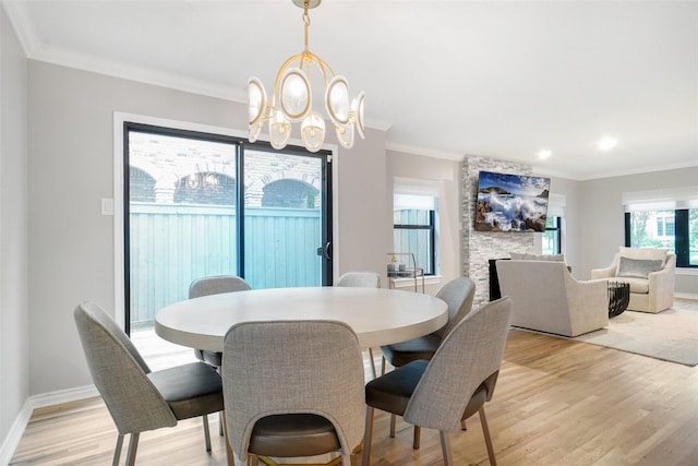 3710 Binkley Ave, University Park, TX 75205 - dining area featuring light wood-type flooring, a chandelier, recessed lighting, a large fireplace, and baseboards