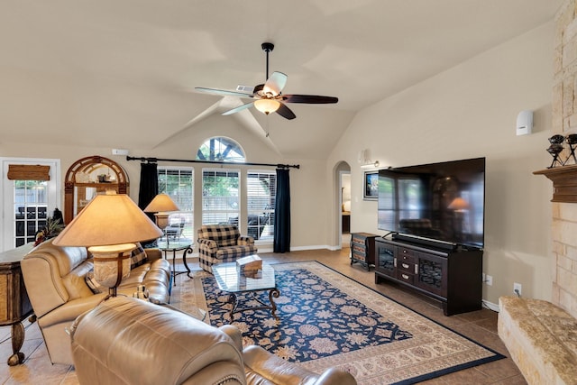 5210 Medallion Ct, Midlothian, TX 76065 - living area with arched walkways, vaulted ceiling, ceiling fan, tile patterned floors, and baseboards