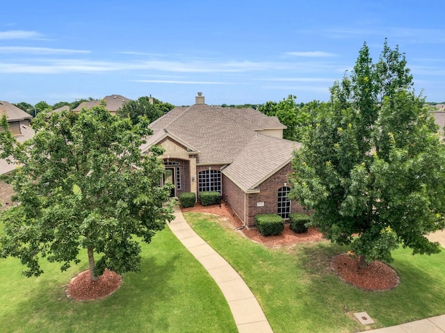 5210 Medallion Ct, Midlothian, TX 76065 - view of front of home with brick siding, a front yard, a shingled roof, and a chimney