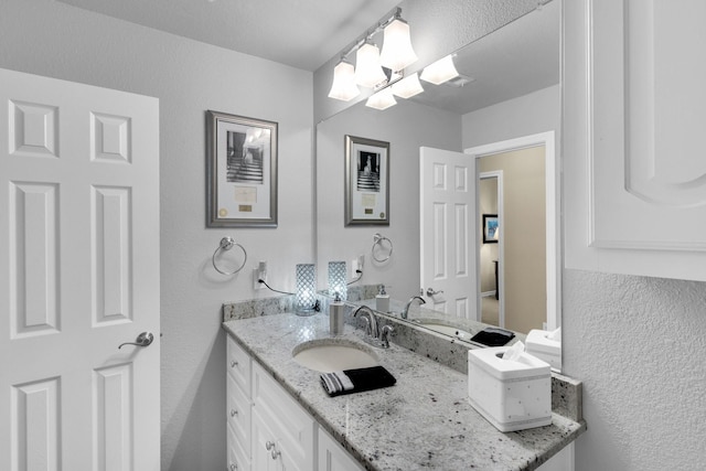 5210 Medallion Ct, Midlothian, TX 76065 - bathroom with vanity, a textured wall, and a chandelier