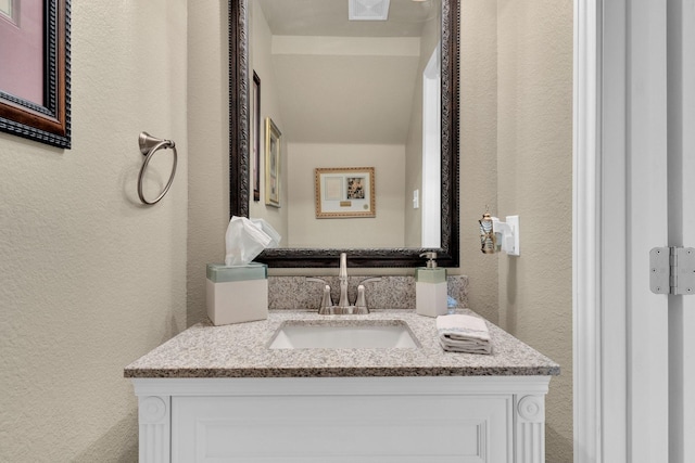 5210 Medallion Ct, Midlothian, TX 76065 - bathroom featuring a textured wall and vanity
