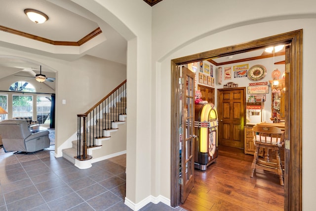 5210 Medallion Ct, Midlothian, TX 76065 - foyer entrance featuring arched walkways, ornamental molding, a ceiling fan, stairs, and baseboards