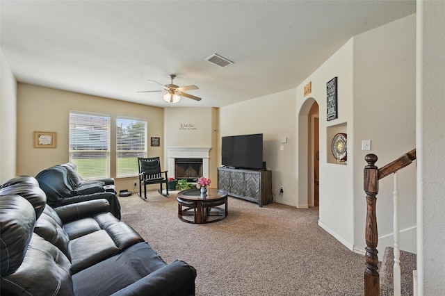 7530 Park Ave, Forest Hill, TX 76140 - carpeted living room with ceiling fan, arched walkways, and a fireplace