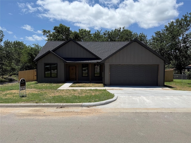 901 SW 10th St, Mineral Wells, TX 76067 - view of front of property featuring roof with shingles, a garage, and driveway