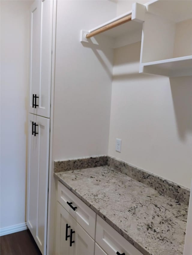 901 SW 10th St, Mineral Wells, TX 76067 - laundry area featuring dark wood-style flooring and baseboards