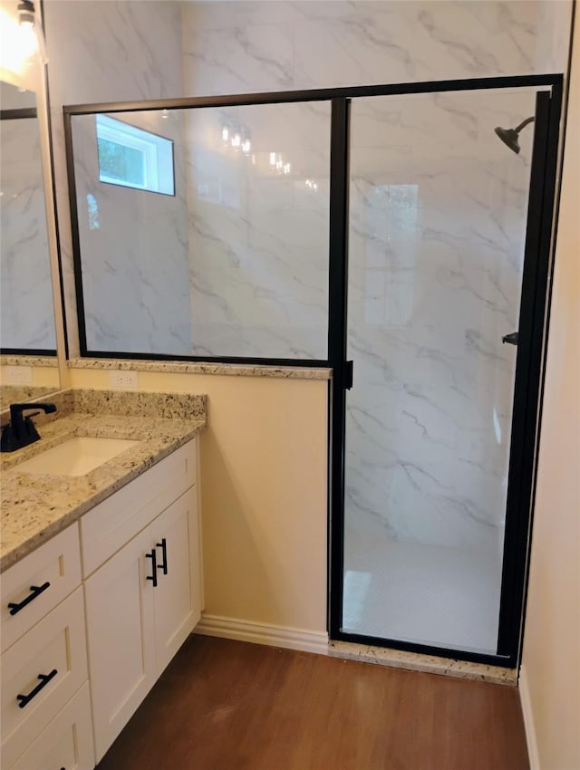 901 SW 10th St, Mineral Wells, TX 76067 - full bathroom featuring vanity, wood finished floors, a marble finish shower, and baseboards