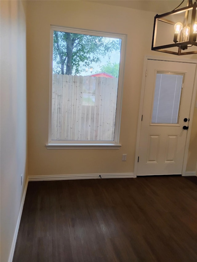 901 SW 10th St, Mineral Wells, TX 76067 - entryway with dark wood-style floors, a chandelier, and baseboards
