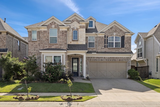 1305 Mary Horn Ln, Aubrey, TX 76227 - view of front facade with concrete driveway, a garage, brick siding, and a shingled roof