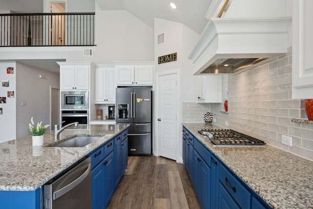 1305 Mary Horn Ln, Aubrey, TX 76227 - kitchen featuring appliances with stainless steel finishes, a sink, blue cabinetry, premium range hood, and high vaulted ceiling