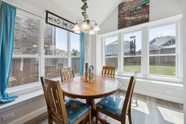 1305 Mary Horn Ln, Aubrey, TX 76227 - dining space featuring wood finished floors, a chandelier, vaulted ceiling, and baseboards