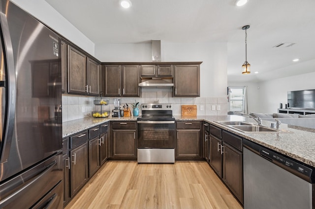 900 Sapphire Dr, Princeton, TX 75407 - kitchen featuring stainless steel appliances, a sink, light wood-style floors, dark brown cabinets, and light stone countertops