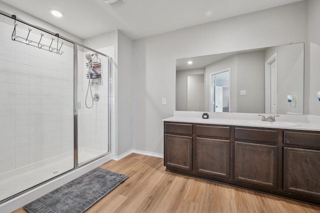 900 Sapphire Dr, Princeton, TX 75407 - bathroom featuring a shower stall, vanity, wood finished floors, baseboards, and recessed lighting
