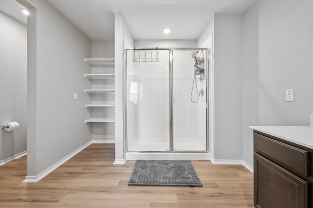 900 Sapphire Dr, Princeton, TX 75407 - bathroom with vanity, a shower stall, wood finished floors, baseboards, and recessed lighting