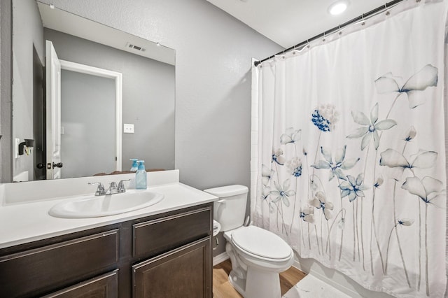 900 Sapphire Dr, Princeton, TX 75407 - bathroom featuring toilet, wood finished floors, vanity, and shower / bath combo with shower curtain