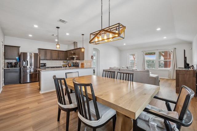 900 Sapphire Dr, Princeton, TX 75407 - dining room with arched walkways, light wood-style floors, and recessed lighting