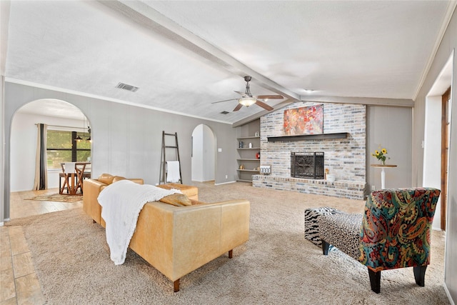 2801 Good Shepherd Dr, Brownwood, TX 76801 - living area with arched walkways, a ceiling fan, a brick fireplace, and crown molding