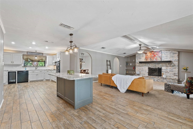 2801 Good Shepherd Dr, Brownwood, TX 76801 - kitchen featuring black dishwasher, light wood-style floors, beverage cooler, ceiling fan, and open floor plan