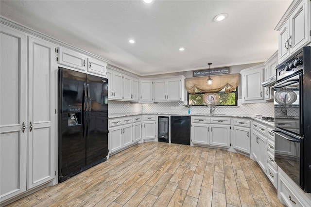2801 Good Shepherd Dr, Brownwood, TX 76801 - kitchen featuring black appliances, backsplash, light wood finished floors, white cabinets, and recessed lighting