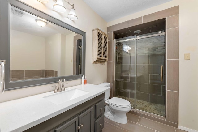 2801 Good Shepherd Dr, Brownwood, TX 76801 - bathroom featuring vanity, toilet, a shower stall, and tile patterned flooring