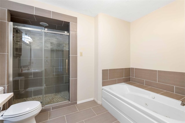 2801 Good Shepherd Dr, Brownwood, TX 76801 - full bath with toilet, a tub with jets, a shower stall, tile patterned floors, and baseboards